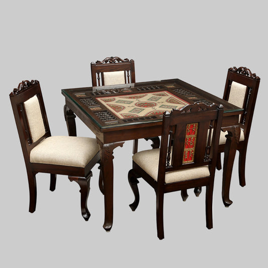 Wooden dining table with intricate design and four matching chairs on a white background